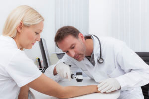 Doctor examining patient's skin