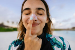 Woman with sunscreen on her nose