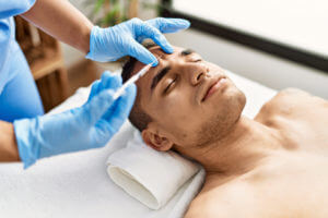 Doctor injecting botox on man face for anti aging treatment